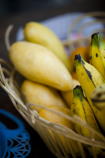 Close-up of bananas and mangoes in basket