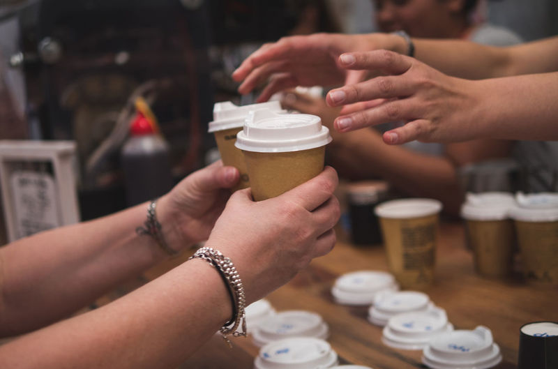 Cropped image of hands holding coffee cup
