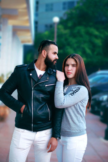 Young couple standing on footpath