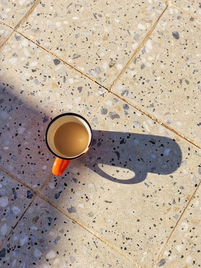 High angle view of coffee cup on floor