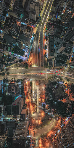 High angle view of illuminated city street and buildings at night
