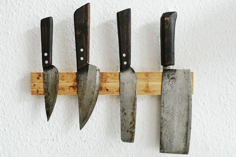 Directly above shot of various knives on wood