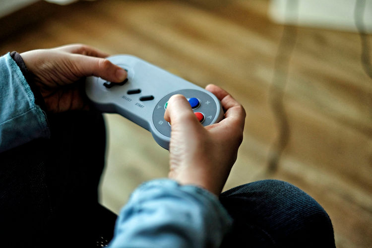 Cropped image of boy playing video game