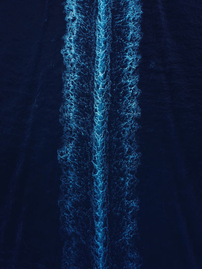 Abstract aerial view of a boat wake pattern