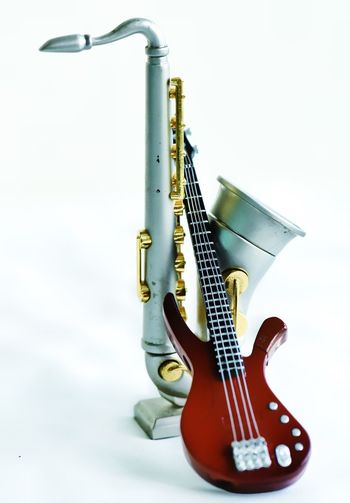 High angle view of guitar on table against white background