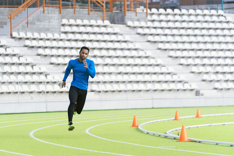 Male athlete running at sports track