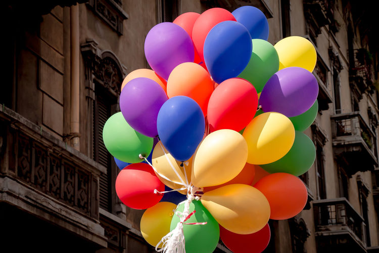 Low angle view of balloons against building