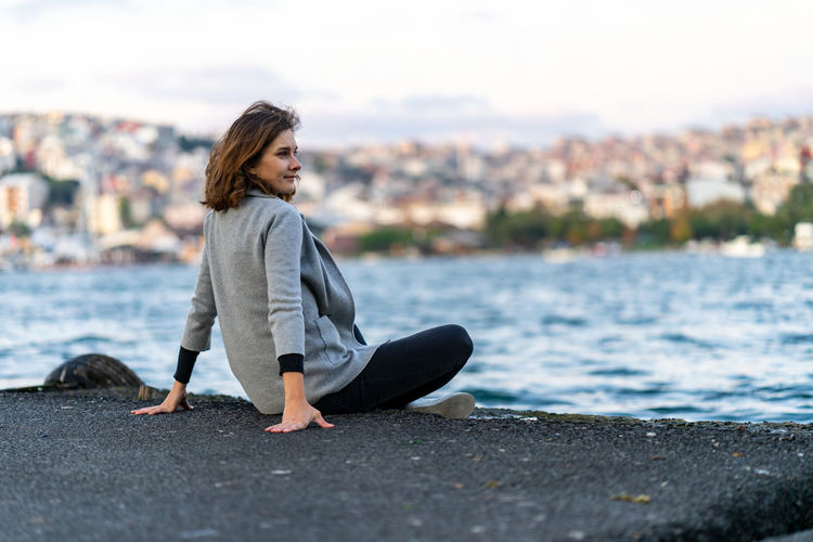 Young woman looking at istanbul hills over golden horn