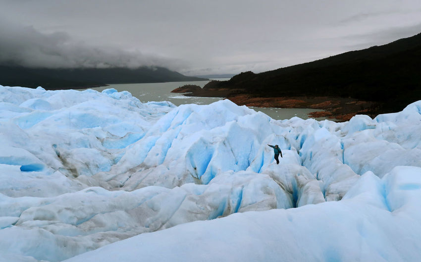 A man walks over the perito moreno glacier in santa cruz, argentina