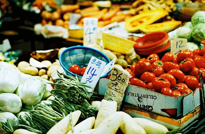 High angle view of fresh vegetables with labels at market stall