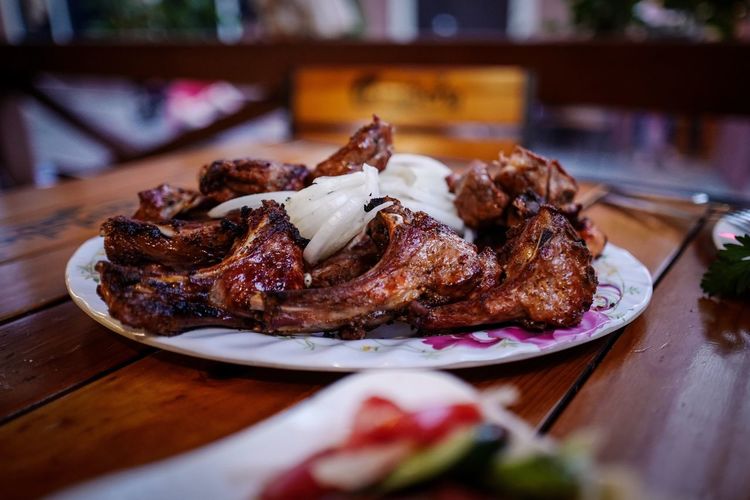 Grilled meat in served plate on table