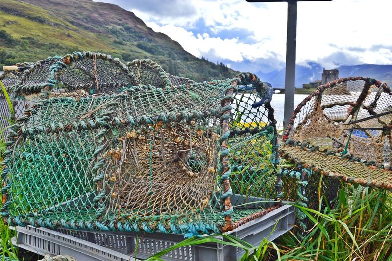 Fishing net on mountain against sky