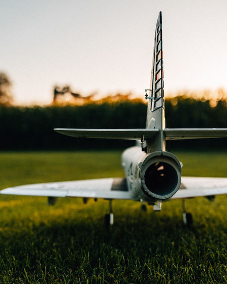 Close-up of airplane on runway against sky