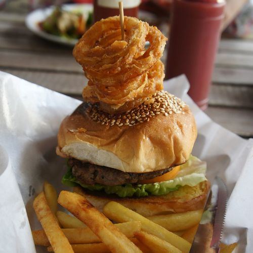 Close-up of burger and french fries on paper