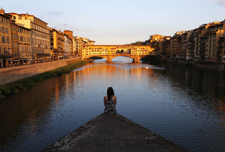 Rear view of woman looking at view of ponte vecchio
