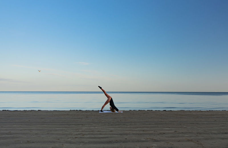 Full length of person on beach against sky