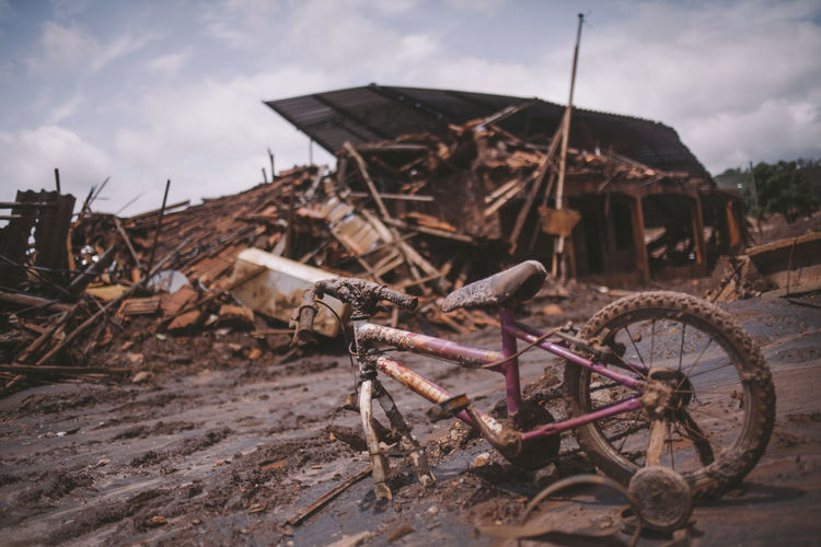 Damaged bicycle and houses by tsunami