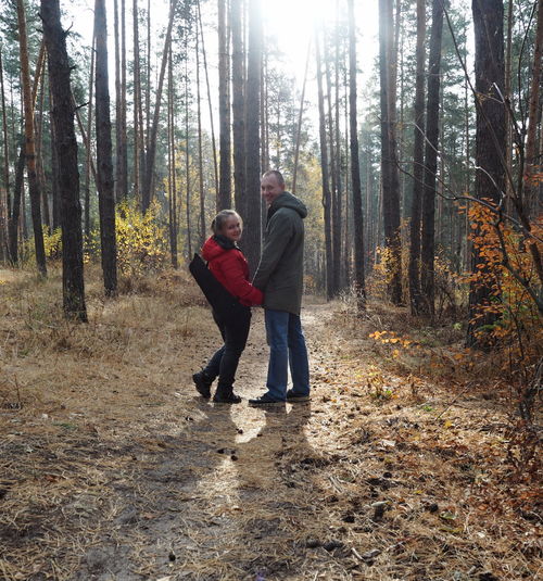 Rear view of man and woman in forest