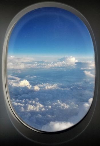 Scenic view of cloudscape seen through airplane window