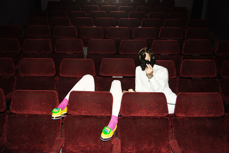 People on red seats at theater