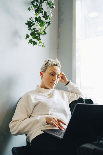 Female entrepreneur using laptop in office