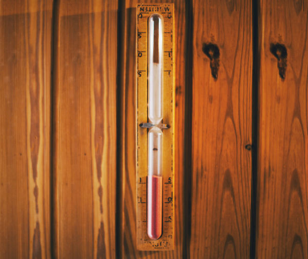 Close-up of thermometer on wooden wall