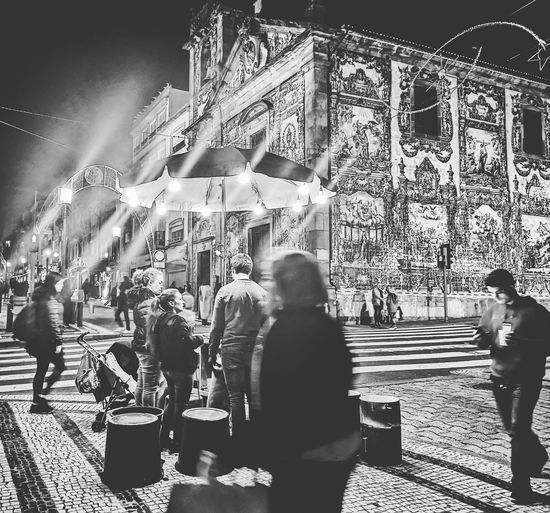People walking on street in city at night