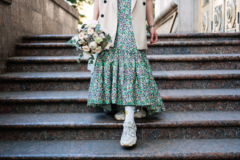 Contemporary modern trendy hipster bride in informal dress and sneakers with edible wedding bridal