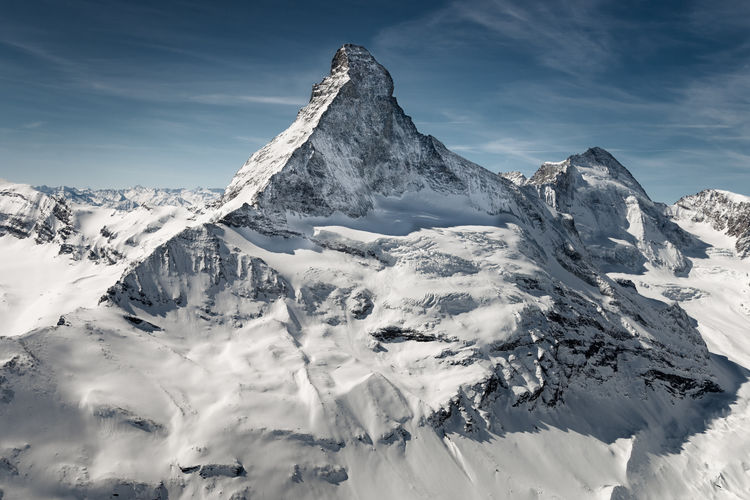 Aerial view of matterhorn mountain in against blue sky, switzerland