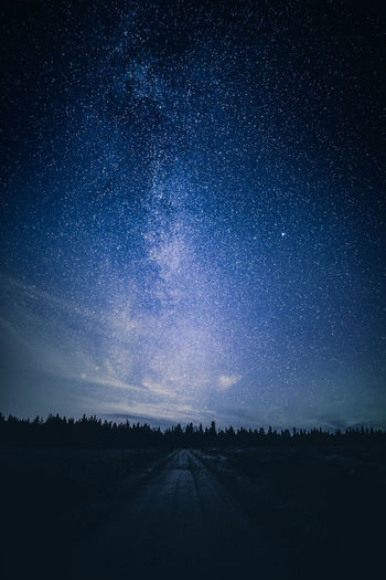 Scenic view of road against sky at night