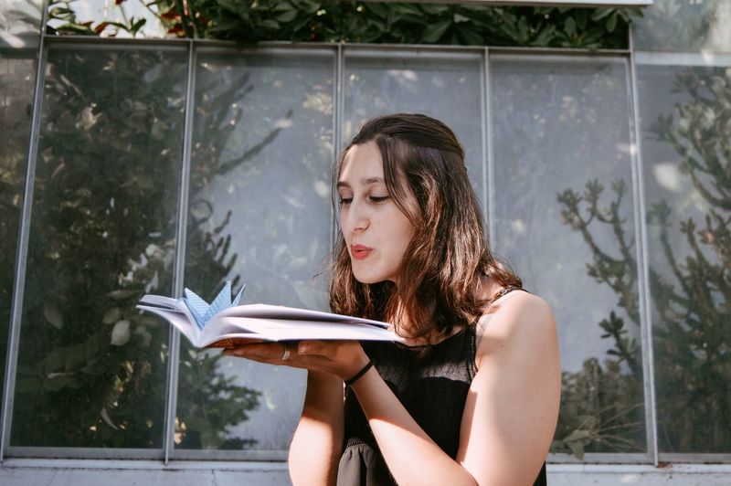 Young woman reading book