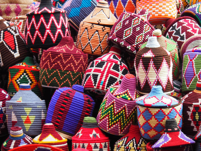 Multi colored baskets for sale at market stall