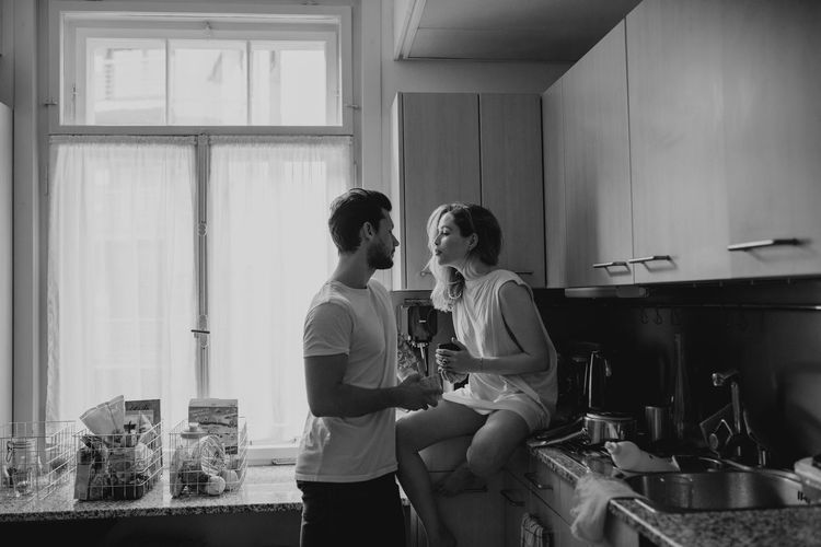 Man and woman standing in kitchen