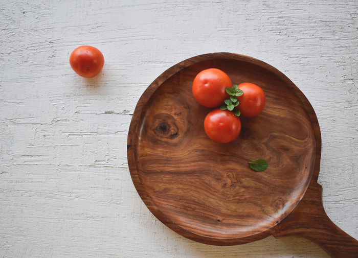 High angle view of cherry tomatoes on cutting board