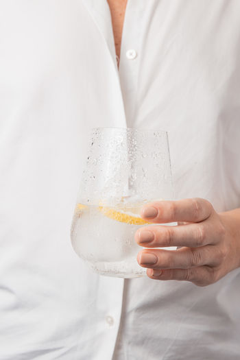 Midsection of woman holding drink
