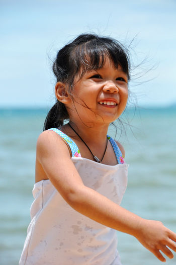 Cute girl standing on beach
