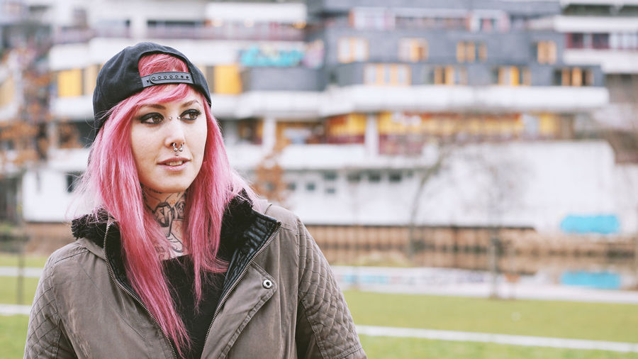 Woman with pink hair at social housing estate