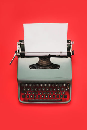 Directly above shot of typewriter on colored background