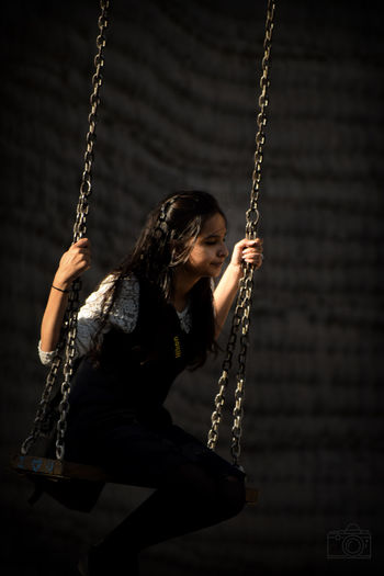Young woman enjoying on swing