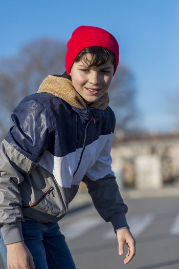 Boy skateboarding on road