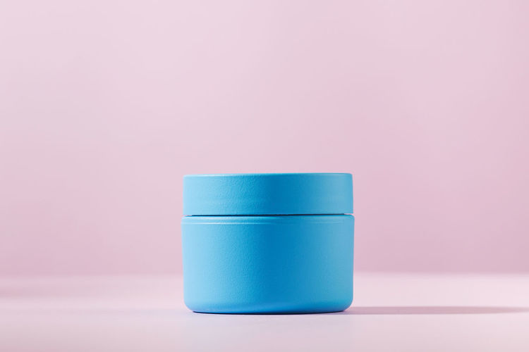 Close-up of cosmetic product over colored background