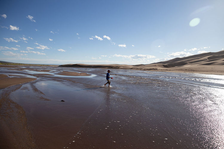 Man on beach against sky