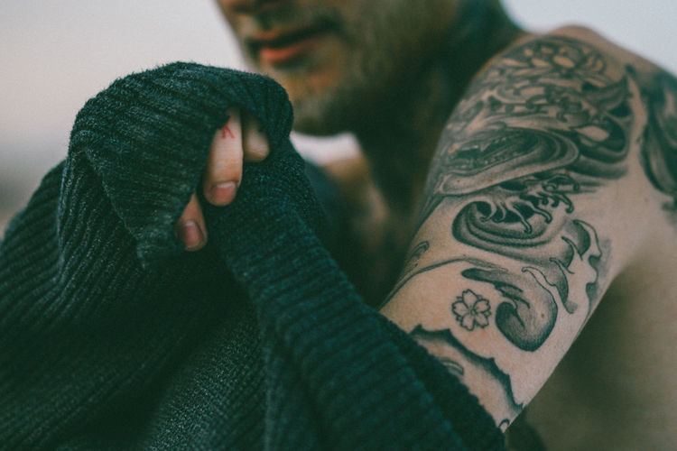Adult Close-up Day Glove Human Body Part Human Hand Indoors Leisure Activity Lifestyles Men One Person People Real People Tattooed Warm Clothing Women