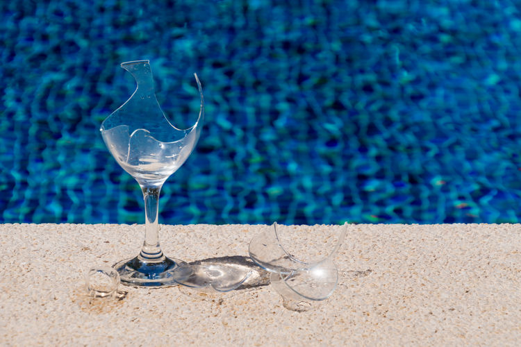 High angle view of broken wineglass at poolside
