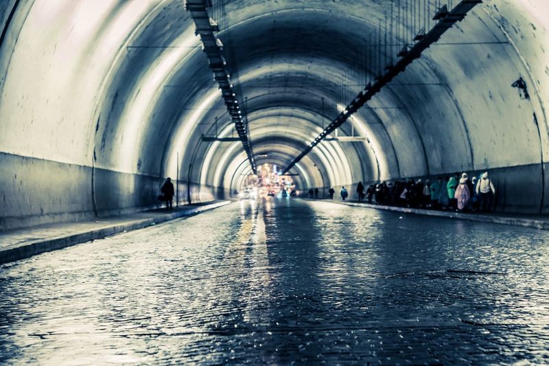 Man walking in illuminated tunnel