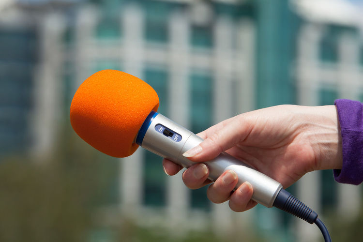 Close-up of hand holding microphone