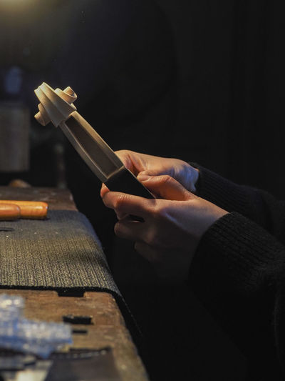 Luthier working a classic violin scroll