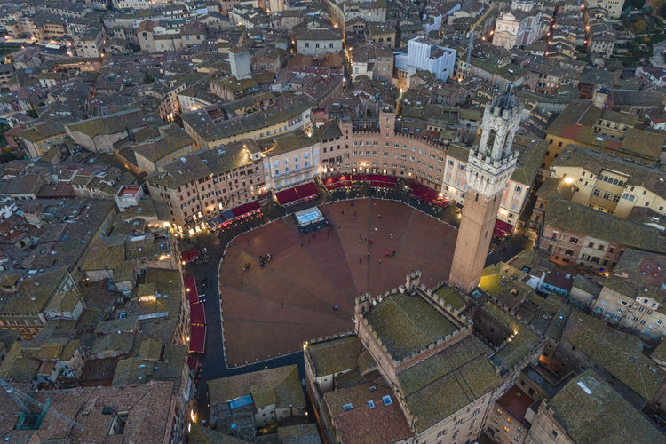 Aerial view of torre del mangia with city skyline at sunset, a famous landmark 