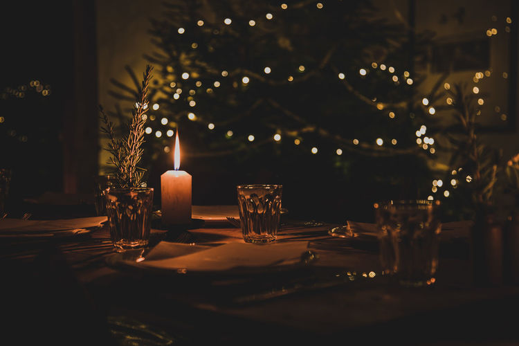 Illuminated christmas decoration on table at night