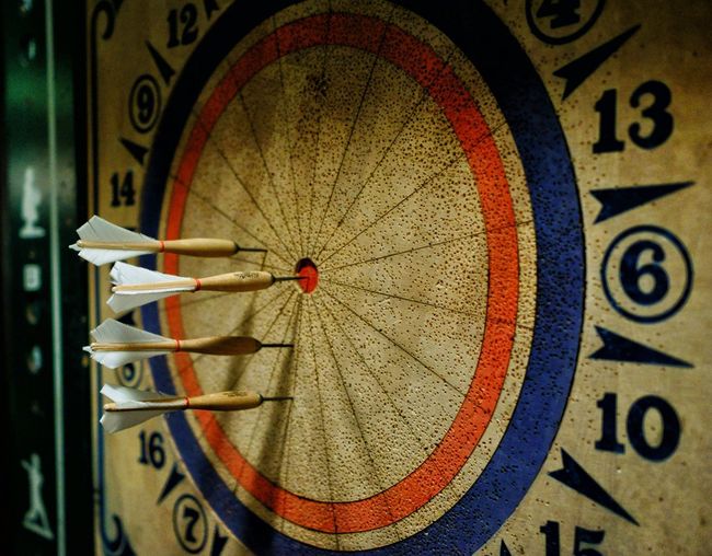 Close-up of dartboards with darts